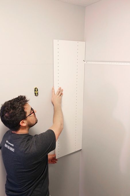 Man installing closet system
