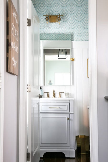 Aqua, Gray, and White Powder Room with Brass Fixtures