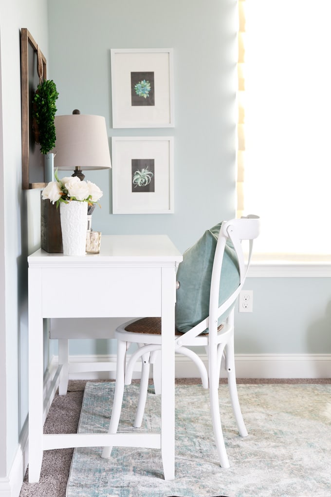 This extremely organized home office is so functional and beautiful at the same time! It gives me so many great ideas for my own home office organization! | home office, craft room, woman cave, home office decor, feminine decor, allover stencil, stenciled wall, IKEA BESTA system, IKEA PAX system, organizing, etagere, pillow organization, organized books, organized binders, organized office supplies, organized craft supplies, IKEA hack, office nook, home office storage, reading corner, aqua office, white writing desk, farmhouse chair, succulent prints