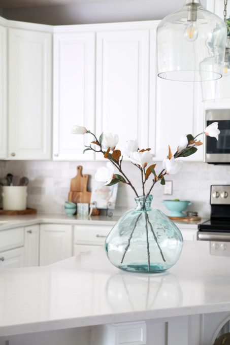 Aqua Demijohn on a Large Kitchen Island in a White Kitchen