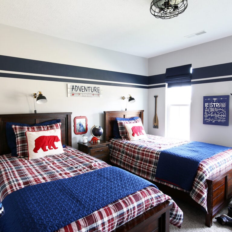 Organized kids bedroom with twin beds and a red and blue color scheme