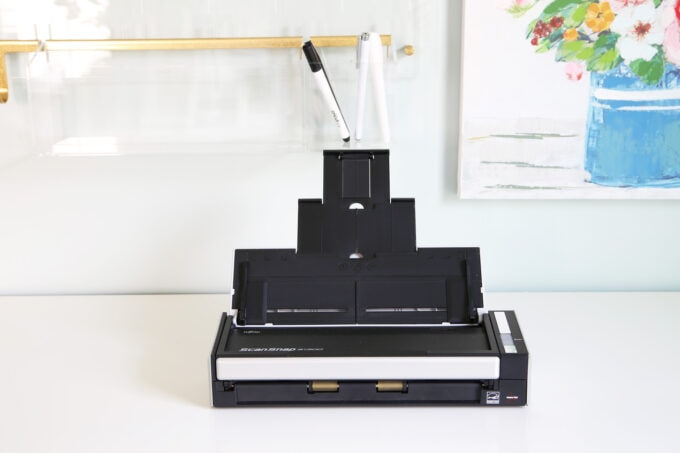 Fujitsu ScanSnap scanner sitting on a white desk