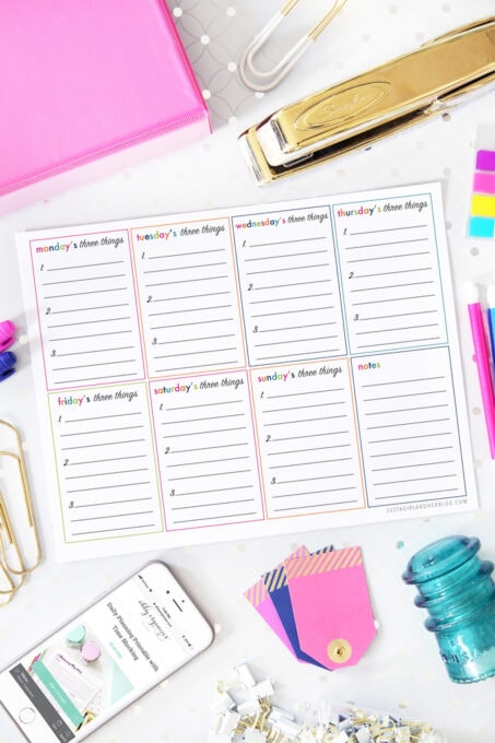 flatlay of daily three things productivity printable with office supplies around it